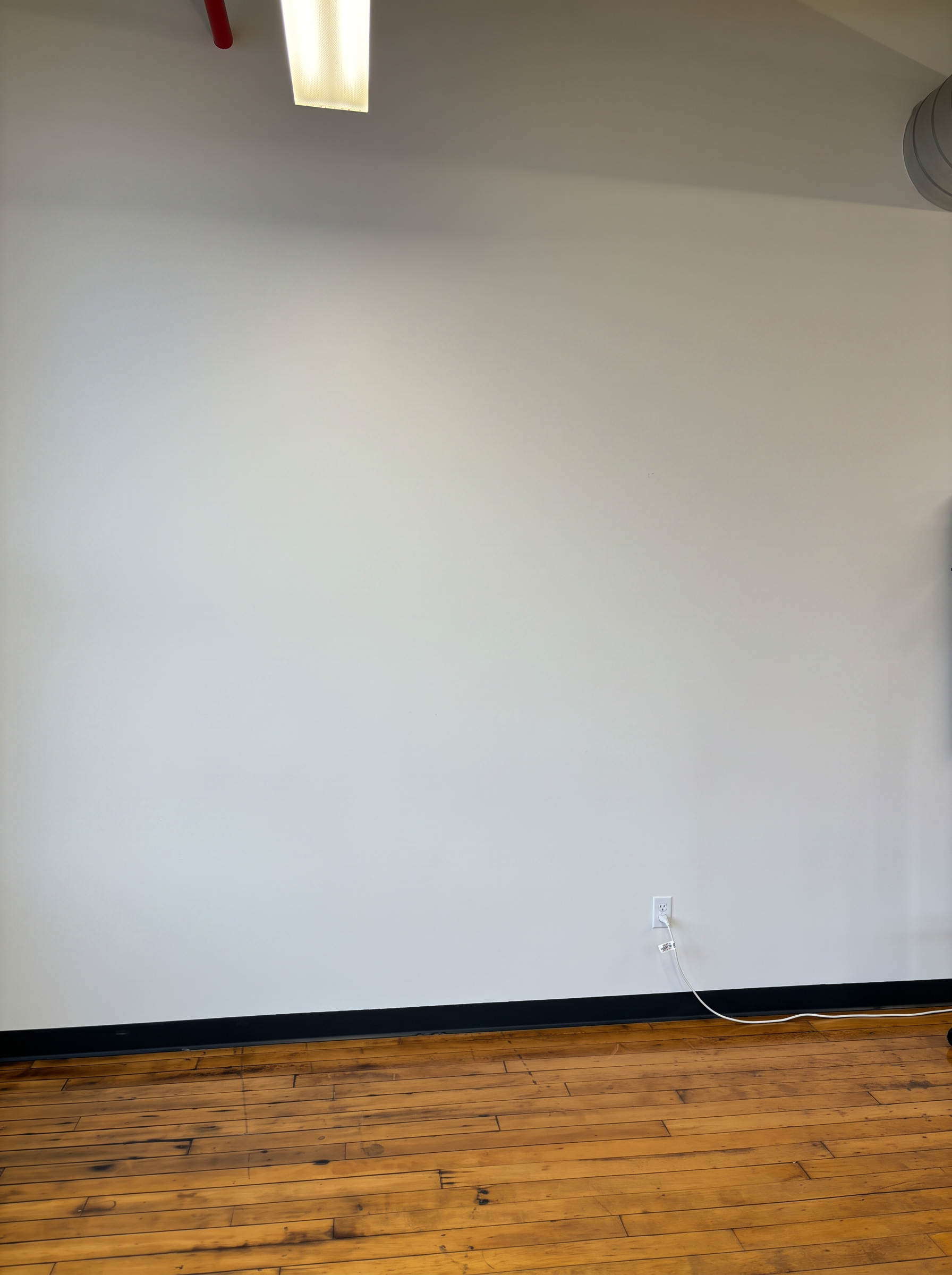 The same wall before printing — blank painted drywall